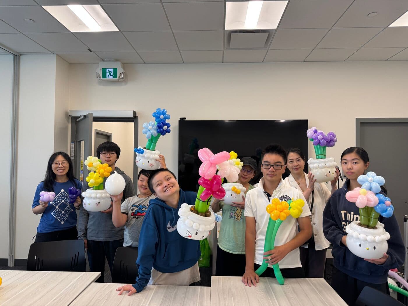 Participants showing their balloon flower creations